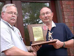 Kevin McMasters, left, presents Steve Beck with the 2007 Arkansas Fire Fighter of the Year award. Beck, a sergeant in the Arkansas Army National Guard, was stationed in Iraq with the 875th Engineer Battalion when he received word he won the honor. Kevin McMasters, left, presents Steve Beck with the 2007 Arkansas Fire Fighter of the Year award. Beck, a sergeant in the Arkansas Army National Guard, was stationed in Iraq with the 875th Engineer Battalion when he received word he won the honor.