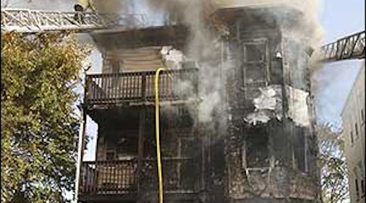 A charred triple-decker house smolders after a three-alarm fire, Nov. 12.