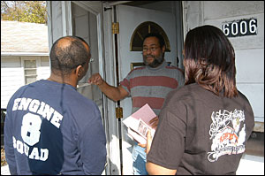 Members from Seat Pleasant Volunteer Fire Department discuss fire safety information with a resident