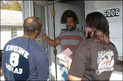 Members from Seat Pleasant Volunteer Fire Department discuss fire safety information with a resident Members from Seat Pleasant Volunteer Fire Department discuss fire safety information with a resident
