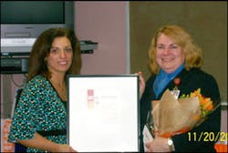 A Dunkin Brands representative presents Diana Pfersick (right) with her awards. A Dunkin Brands representative presents Diana Pfersick (right) with her awards.
