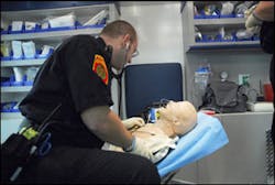 A paramedic performs a survey of the mannequin in the new high-tech simulator. A paramedic performs a survey of the mannequin in the new high-tech simulator.