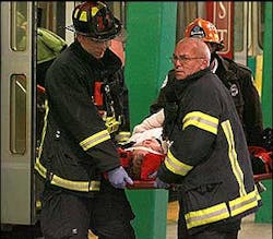 Emergency workers transport an injured passenger from the crash, Dec. 13.