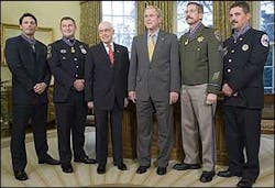Richmond Firefighter David Loving, far right, is accompanied by, from left: Officer Kevin Howland of Sacramento; Officer Todd Myers of West Hartford, Conn.; Attorney General Mukasey; President Bush and Sgt. Kirk Van Orsdel of Hemet, Calif.