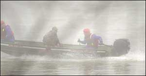 Sugar Creek Water Rescue members transport Ted Kuhn back to the Michael Hunter Kearns public access site boat ramp Tuesday near Tecumseh after they pulled Kuhn from the Wabash River.