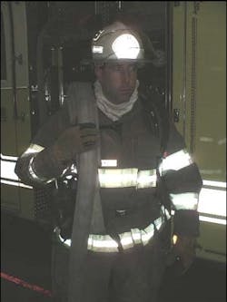 Photo No.6: Here the Backup firefighter has his shoulder load properly draped on his shoulder, leaving his opposite hand free to help move up a stairway, past occupants, or pull a chock from his helmet band or pocket. Photo No.6: Here the Backup firefighter has his shoulder load properly draped on his shoulder, leaving his opposite hand free to help move up a stairway, past occupants, or pull a chock from his helmet band or pocket.