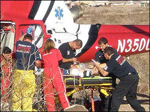 Bullhead City Fire Department Paramedics along with Care Flight Air Ambulance Crew prepare a yong male for transport the University Medical Center in Las Vegas.