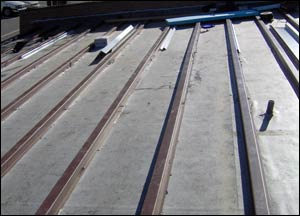 An EDPM membrane with and hat channels over existing deck. A metal roof will be attached to the hat channels.