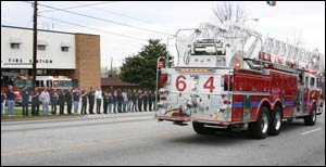 Dozens of firefighters and mourners lined the streets as the procession passed by.
