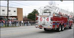 Dozens of firefighters and mourners lined the streets as the procession passed by. Dozens of firefighters and mourners lined the streets as the procession passed by.