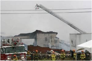Firefighters gather at the scene of the tragic fire.