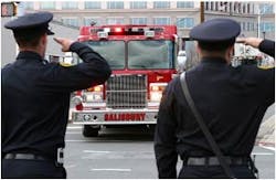 Public saPublic safety officials salute a Salibury fire truck as it escorts the bodies of fallen firefighters Vistor Isler and Justin Monroe to the medical examiners office on March 8.