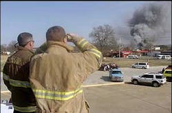 Fort Smith, Ark. firefighters Chris Taylor, left, and James Wood watch from the roof of a fire truck as smoke billows from the Cargill Meat Processing plant, March 23. Fort Smith, Ark. firefighters Chris Taylor, left, and James Wood watch from the roof of a fire truck as smoke billows from the Cargill Meat Processing plant, March 23.