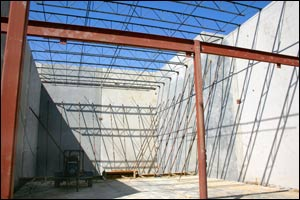 The structural assembly of this building is comprised of steel I-beams, steel bar joists, and concrete walls.
