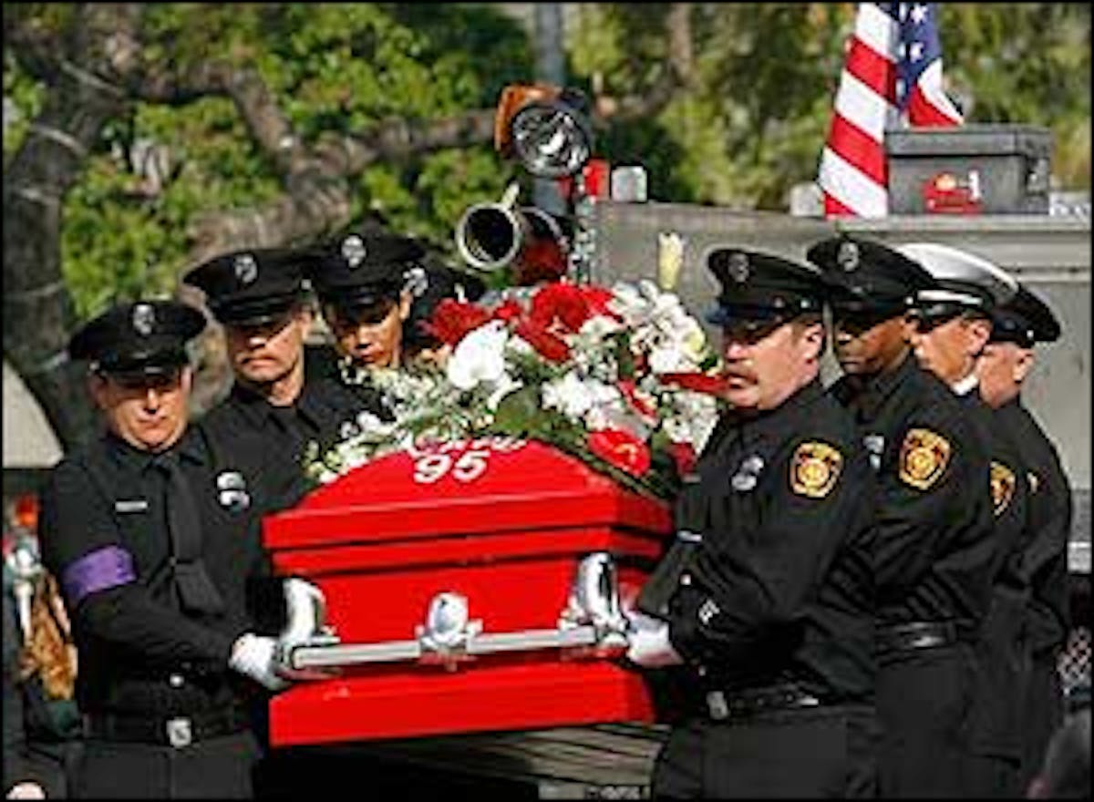 Los Angeles firefighters carry the coffin of veteran firefighter Brent Lovrien, into the Cathedral of Our Lady of the Angels, April 4.