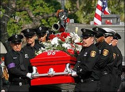Los Angeles firefighters carry the coffin of veteran firefighter Brent Lovrien, into the Cathedral of Our Lady of the Angels, April 4.