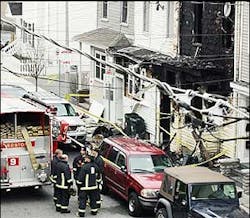 Firefighters and crime-scene investigators combed through the scene at 154 West 6th St. after a fire ripped through the three-decker home, April 6.