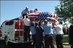Macon firefighters load the casket of their chief onto the engine on Tuesday. Macon firefighters load the casket of their chief onto the engine on Tuesday.