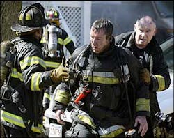 Scorched firefighters exit the front of of a three alarm blaze on Harrison Street in Brookline. Scorched firefighters exit the front of of a three alarm blaze on Harrison Street in Brookline.