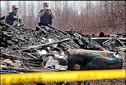 Investigators work at the scene of a fatal fire in Eastbrook on April 20 that killed the 13-year-old son of the local fire chief.