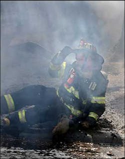 A firefighter is knocked to the ground during a blaze on Central Street in Saugus yesterday. A firefighter is knocked to the ground during a blaze on Central Street in Saugus yesterday.
