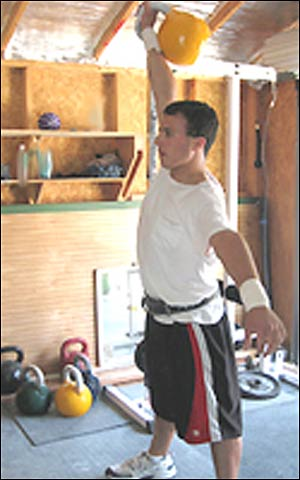 Firefighter hopeful Joe C. does a workout with kettlebells.
