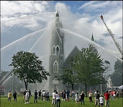 People gather on Lynn Common to watch firefighters battle a blaze at the historic First Baptist Church. People gather on Lynn Common to watch firefighters battle a blaze at the historic First Baptist Church.