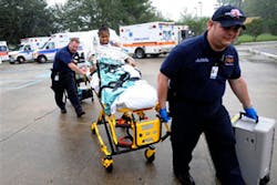Paramedics return one of 75 patients to Trinity Neurologic Rehabilitation Center in Slidell, La., Tuesday, Sept. 2, 2008. Paramedics return one of 75 patients to Trinity Neurologic Rehabilitation Center in Slidell, La., Tuesday, Sept. 2, 2008.