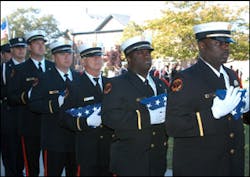 Charleston firefighters wait to present flags for the families of their fallen comrades. Charleston firefighters wait to present flags for the families of their fallen comrades.