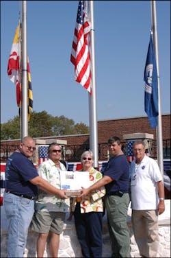 Brandon Thompson's brothers, Jeff, left, and Frank hold a brick from the Sofa Super Store while their parents, Frank Thompson and Diane White, hold an article about the deadly blaze. Retired New Bedford Chief Roger Nadeau assisted them this weekend. Brandon Thompson's brothers, Jeff, left, and Frank hold a brick from the Sofa Super Store while their parents, Frank Thompson and Diane White, hold an article about the deadly blaze. Retired New Bedford Chief Roger Nadeau assisted them this weekend.