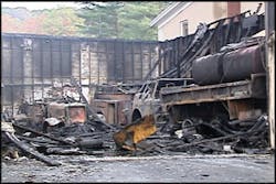 Charred equipment remains in the debris of the burned-out building.
