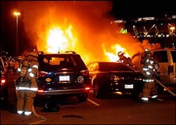 Firefighters work to contain a fire that damaged nine vehicles in the parking lot of FedEx Field on Monday Night. Firefighters work to contain a fire that damaged nine vehicles in the parking lot of FedEx Field on Monday Night.
