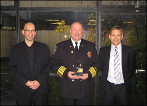 Roseville, MN, Fire Chief Dr. Richard B. Gasaway (center) was presented the 2008 FIRE/W.L. Gore Research Excellence Award by Andrew Lynch (left), Editor of the British FIRE Journal and John Morton (right) from W. L. Gore and Associates.