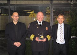 Roseville, MN, Fire Chief Dr. Richard B. Gasaway (center) was presented the 2008 FIRE/W.L. Gore Research Excellence Award by Andrew Lynch (left), Editor of the British FIRE Journal and John Morton (right) from W. L. Gore and Associates.