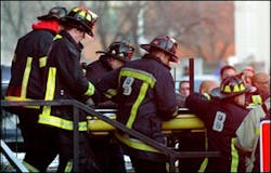 Firefighters remove the body of Lt. Kevin Kelly following the tragic crash. Firefighters remove the body of Lt. Kevin Kelly following the tragic crash.