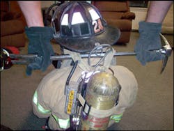 The Halligan tool can be slid under both of the shoulder straps and allows a second firefighter to help remove the downed member.