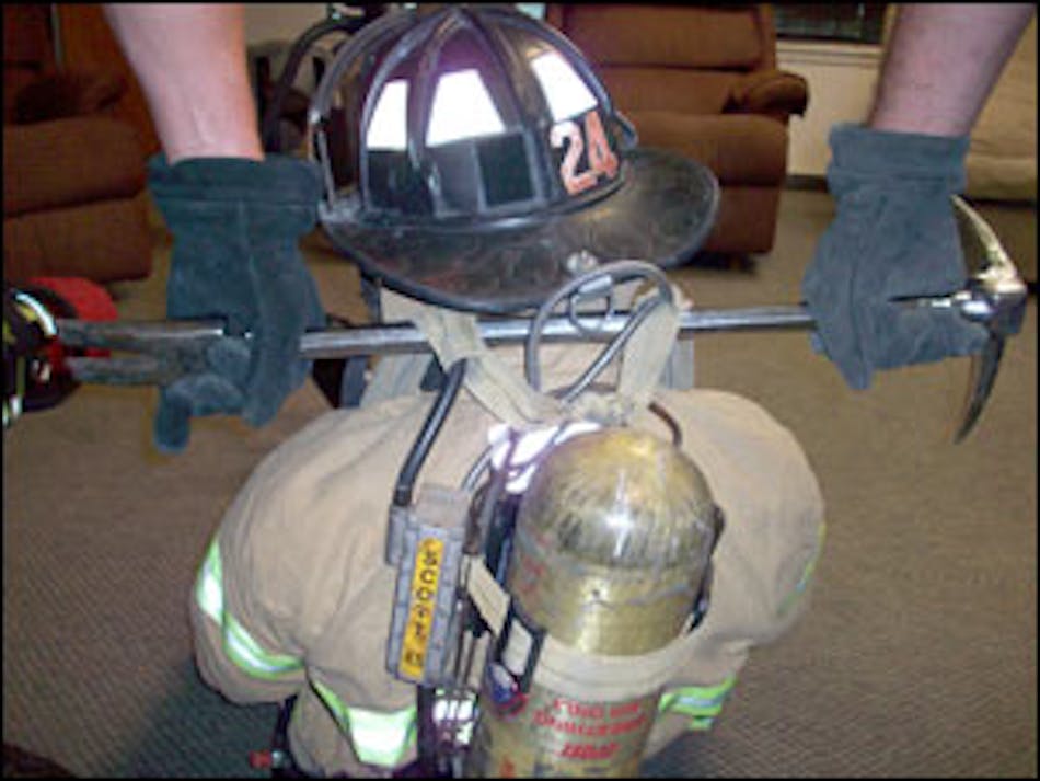 The Halligan tool can be slid under both of the shoulder straps and allows a second firefighter to help remove the downed member.