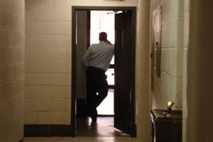 A fire official watches the throngs below