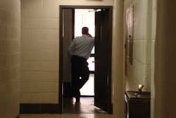 A fire official watches the throngs below A fire official watches the throngs below
