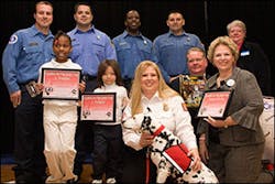 Dystiny, Angelica and the Tulsa firefighters that responded to the blazes shown -- with Sparkles and handler Firefighter Dayna Hilton -- were honored at a recent school assembly.