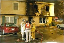 Charlotte firefighters talk at the scene of a fatal fire at the Silver Oak Apartments early Saturday.