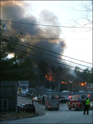 Smoke is seen from a fire raging through the Christian Conference Center that damaged dozens of buildings.