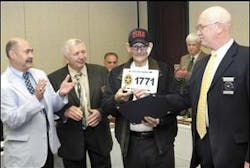 State Fire Marshal Sterling Lewis, right, presents Louis Dale &apos;Sonny&apos; Farthing, a 30-year firefighter who has terminal cancer, with a West Virginia State Fire Marshal unit number license plate Friday. Also pictured are Rick Rice, left, director of RESA 1 and 4, and Dave Tolliver with the State Fire Commission.