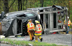 Firefighters examine the wreckage of a Bradley-Prosperity Volunteer Fire Department rescue truck after it crashed Tuesday while traveling on the West Virginia Turnpike.
