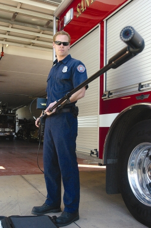 Victor Maccharoli- City firefighter Spencer Simonds holds a rescue camera donated by the Santa Barbara Firefighters Alliance, a volunteer, nonprofit group that raises money for the city and county fire departments.