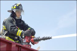 Petty Officer 3rd Class Phil Brown operates the master stream on top of a fire truck during a training drill. The master stream can pump out approximately 1,250 gallons of water per minute. Petty Officer 3rd Class Phil Brown operates the master stream on top of a fire truck during a training drill. The master stream can pump out approximately 1,250 gallons of water per minute.