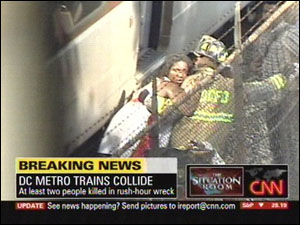This image made from television shows a firefighter helping an injured woman following a collision between two Metro transit trains in northeast Washington near the Washington-Maryland border on the Metro system's red line.