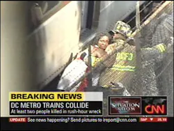 This image made from television shows a firefighter helping an injured woman following a collision between two Metro transit trains in northeast Washington near the Washington-Maryland border on the Metro system's red line.
