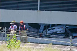 Firefighters look at damaged vehicles in a collapsed garage in Atlanta, Monday June 29, 2009. Part of a six-floor parking deck at a building near downtown Atlanta collapsed crushing dozens of cars, but there were no immediate reports of injuries.