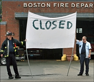 Boston firefighters picket at the Neponset Ave. station, one of three firehouses where fire apparatus have been put out of service due to budget shortfalls.